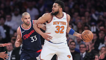 Mar 26, 2025; New York, New York, USA;  New York Knicks center Karl-Anthony Towns (32) looks to drive past LA Clippers forward Nicolas Batum (33) in the first quarter at Madison Square Garden. Mandatory Credit: Wendell Cruz-Imagn Images