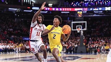 Oct 25, 2025; New York, NY, USA;  Michigan Wolverines guard L.J.C.ason (2) looks to drive past St. John's Red Storm guard Ian Jackson (11) in the first half at Madison Square Garden. 