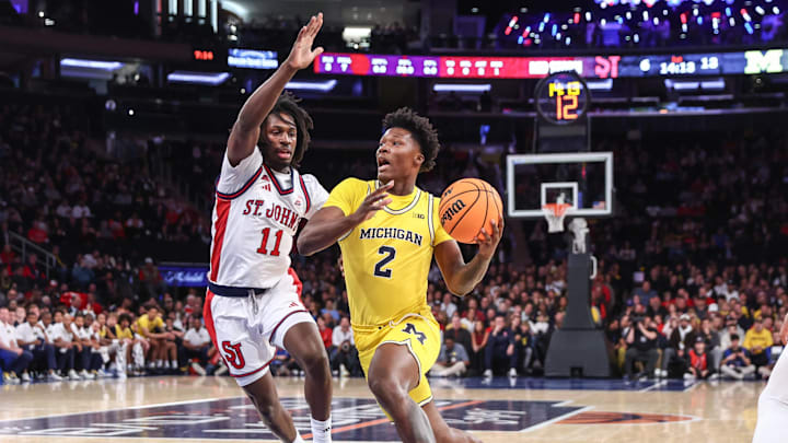 Oct 25, 2025; New York, NY, USA;  Michigan Wolverines guard L.J.C.ason (2) looks to drive past St. John's Red Storm guard Ian Jackson (11) in the first half at Madison Square Garden. 