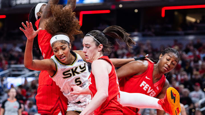 May 17, 2025; Indianapolis, Indiana, USA; Indiana Fever guard Caitlin Clark steals the ball from Chicago Sky forward Angel Reese / Trevor Ruszkowski-Imagn Images