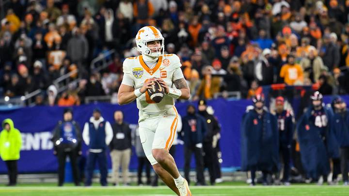 Dec 30, 2025; Nashville, TN, USA;  Tennessee Volunteers quarterback Joey Aguilar (6) rolls out against the Illinois Fighting Illini during the first half at Nissan Stadium. Mandatory Credit: Steve Roberts-Imagn Images