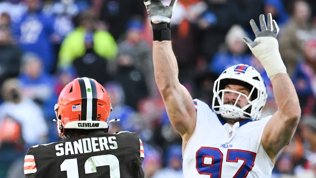 Dec 21, 2025; Cleveland, Ohio, USA;  Buffalo Bills defensive end Joey Bosa (97) tips the pass by Cleveland Browns quarterback Shedeur Sanders (12) which then was later intercepted on the play during the second half at Huntington Bank Field. Mandatory Credit: Ken Blaze-Imagn Images