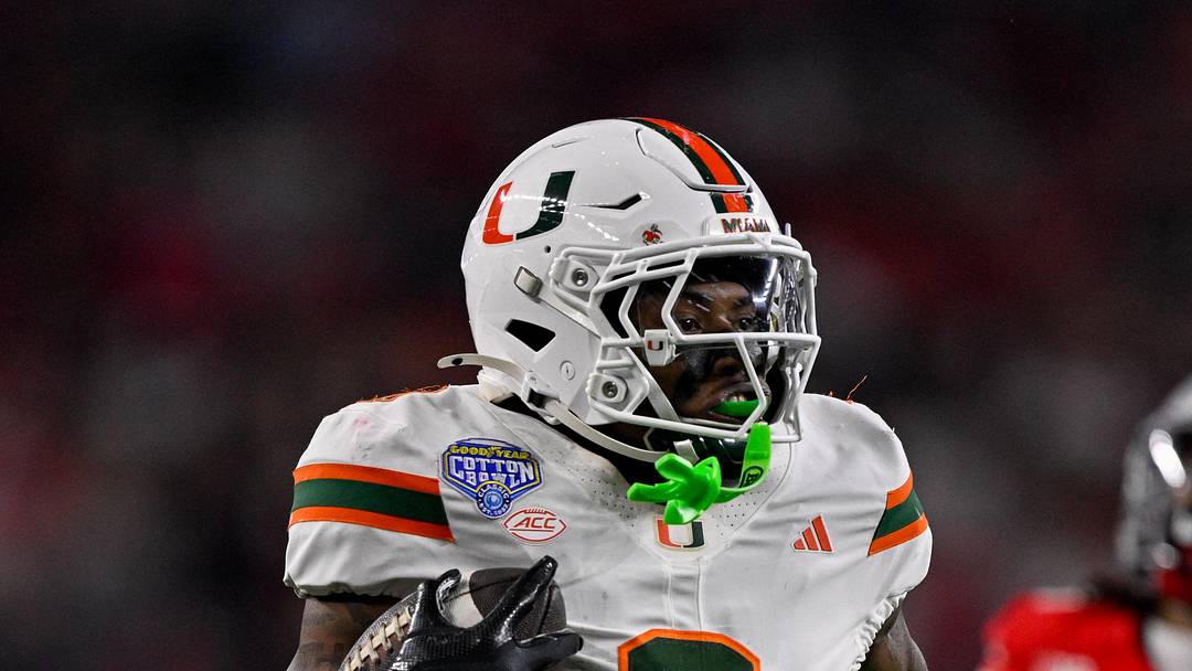 Dec 31, 2025; Arlington, TX, USA; Miami Hurricanes defensive back Keionte Scott (0) returns an interception for a touchdown during the 2025 Cotton Bowl and quarterfinal game of the College Football Playoff at AT&T Stadium. Mandatory Credit: Jerome Miron-Imagn Images