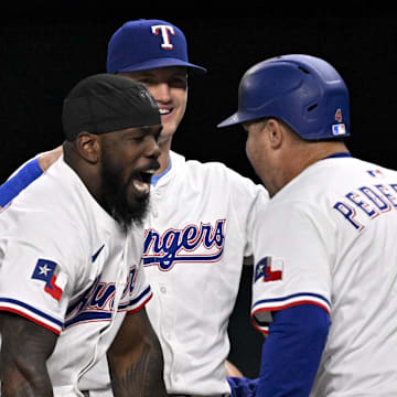 Aug 4, 2025; Arlington, Texas, USA; Texas Rangers pinch hitter Joc Pederson (4) celebrates with right fielder Adolis Garcia (53) and designated hitter Josh Jung (6) after Pederson hits a game tying home run against the New York Yankees during the ninth inning at Globe Life Field. 