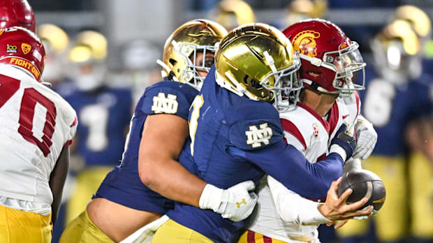 Caleb Williams is sacked by Notre Dame's Jaylen Sneed in the 2023 game between the Fighting Irish and US