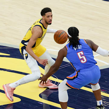 Jun 19, 2025; Indianapolis, Indiana, USA; Indiana Pacers guard Tyrese Haliburton (0) dribbles the ball defended by Oklahoma City Thunder guard Luguentz Dort (5) in the second quarter during game six of the 2025 NBA Finals at Gainbridge Fieldhouse. Mandatory Credit: Trevor Ruszkowski-Imagn Images