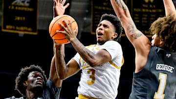 Jan 28, 2025; South Bend, Indiana, USA; Notre Dame Fighting Irish guard Markus Burton (3) goes up for a shot between Georgia Tech Yellow Jackets forward Ibrahim Souare (30) and guard Naithan George (1) in the first half at the Purcell Pavilion. 