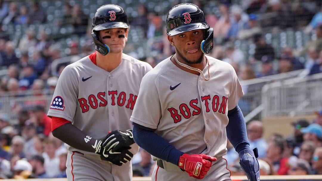Apr 15, 2026; Minneapolis, Minnesota, USA; Boston Red Sox right fielder Roman Anthony (left) and center fielder Ceddanne Rafaela return to the dugout after scoring against the Minnesota Twins in the sixth inning on a double by shortstop Trevor Story (not pictured) at Target Field. Mandatory Credit: Bruce Kluckhohn-Imagn Images