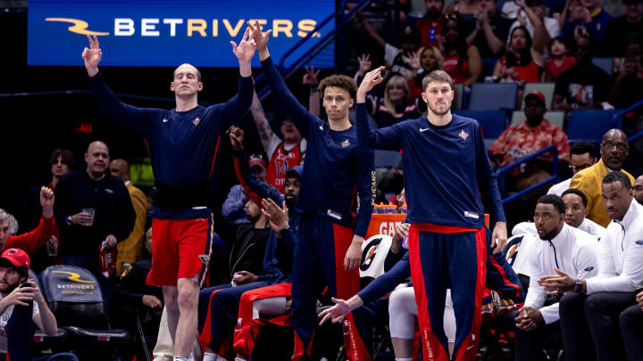 Mar 30, 2024; New Orleans, Louisiana, USA;  New Orleans Pelicans guard Dyson Daniels (11) and center Cody Zeller (40) and forward Matt Ryan (37) react to a three-point basket against the Boston Celtics during the first half at Smoothie King Center. 