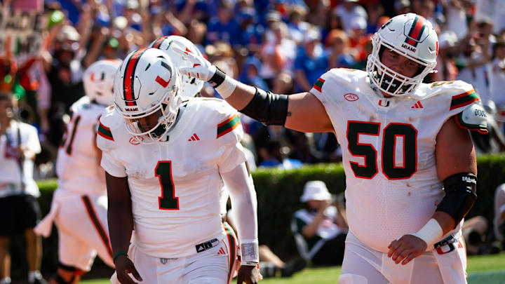 Miami Hurricanes quarterback Cam Ward (1) is congratulated by Miami Hurricanes center Zach Carpenter. Miami Hurricanes quarterback Cam Ward (1) is congratulated by Miami Hurricanes center Zach Carpenter.
