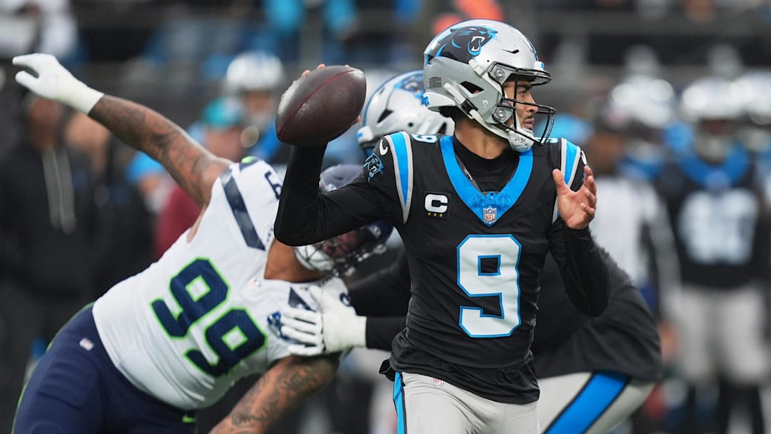 Dec 28, 2025; Charlotte, North Carolina, USA; Carolina Panthers quarterback Bryce Young (9) throws a pass against Seattle Seahawks defensive end Leonard Williams (99) during the first quarter at Bank of America Stadium. Mandatory Credit: Jim Dedmon-Imagn Images