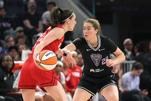 Golden State Valkyries guard Kate Martin (20) defends against Indiana Fever guard Caitlin Clark (left)