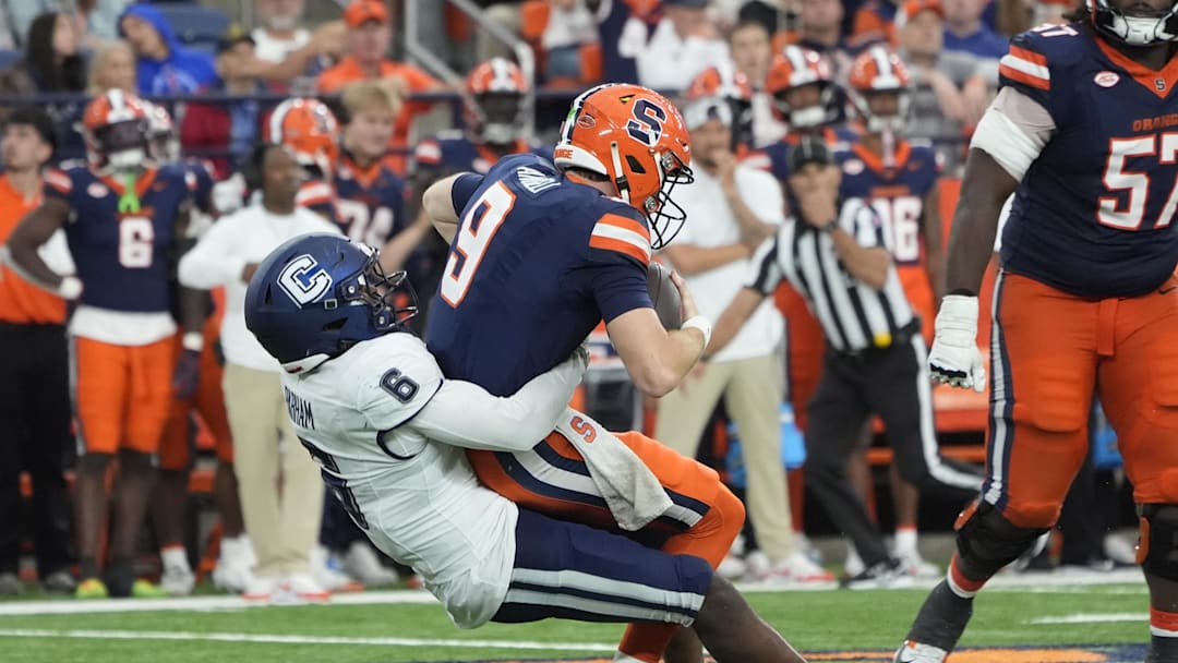 Sep 6, 2025; Syracuse, New York, USA; UConn Huskies linebacker Bryun Parham (6) sacks Syracuse Orange quarterback Steve Angeli (9) during the second half at JMA Wireless Dome. Mandatory Credit: Gregory Fisher-Imagn Images