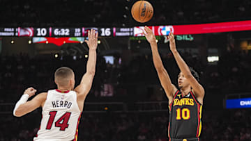 Apr 18, 2025; Atlanta, Georgia, USA; Atlanta Hawks forward Zaccharie Risacher (10) shoots over Miami Heat guard Tyler Herro (14) during the first half at State Farm Arena. Mandatory Credit: Dale Zanine-Imagn Images