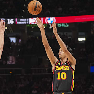 Apr 18, 2025; Atlanta, Georgia, USA; Atlanta Hawks forward Zaccharie Risacher (10) shoots over Miami Heat guard Tyler Herro (14) during the first half at State Farm Arena. Mandatory Credit: Dale Zanine-Imagn Images