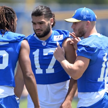 May 28, 2024; Thousand Oaks, CA, USA; Los Angeles Rams wide receiver Demarcus Robinson (15), wide receiver Puka Nacua (17) and wide receiver Cooper Kupp (10) talk during OTAs at California Lutheran University. Mandatory Credit: Jayne Kamin-Oncea-USA TODAY Sports