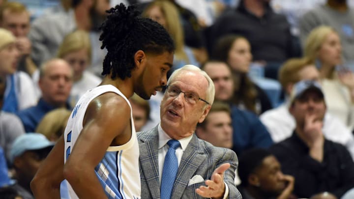 Jan 2, 2019; Chapel Hill, NC, USA; North Carolina Tar Heels head coach Roy Williams (right) talks to guard Coby White (2) during the second half against the Harvard Crimson at Dean E. Smith Center.  The Tar Heels won 77-57.  Mandatory Credit: Rob Kinnan-Imagn Images
