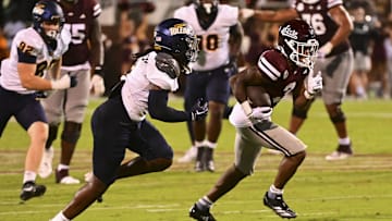 Sep 14, 2024; Starkville, Mississippi, USA; Mississippi State Bulldogs wide receiver Kevin Coleman Jr. (3) runs the ball while defended by Toledo Rockets linebacker Jackson Barrow (5) during the fourth quarter at Davis Wade Stadium at Scott Field. Mandatory Credit: Matt Bush-Imagn Images