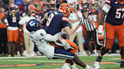 Sep 6, 2025; Syracuse, New York, USA; UConn Huskies linebacker Bryun Parham (6) sacks Syracuse Orange quarterback Steve Angeli (9) during the second half at JMA Wireless Dome. Mandatory Credit: Gregory Fisher-Imagn Images