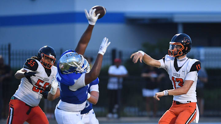 IMG Academy defensive lineman Cameron McHaney (#95) tips a pass from Cocoa High quarterback Brady Hart (#13). The IMG Academy National squad hosted the Cocoa High School Tigers Friday, Sept. 6, 2024 in Bradenton.