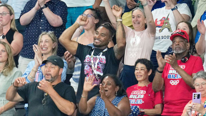 Aug 1, 2024; Paris, France; Jonathan Owens, Nellie Biles, and Ronald Biles celebrates after Simone Biles of the United States won gold in the womenís gymnastics all-around during the Paris 2024 Olympic Summer Games at Bercy Arena. 