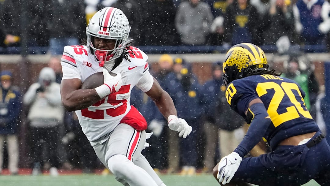 Ohio State Buckeyes running back Bo Jackson (25) runs past Michigan Wolverines defensive back Jyaire Hill (20) during the NCAA football game at Michigan Stadium in Ann Arbor, Mich. on Nov. 29, 2025. Ohio State won 27-9.