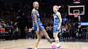Minnesota Lynx guard Courtney Williams (10) and guard Natisha Hiedeman (2) celebrate their teams win against the New York Liberty after the game at Target Center. 
