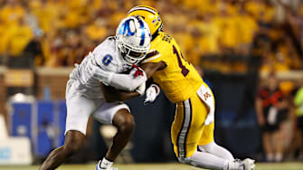 Aug 28, 2025; Minneapolis, Minnesota, USA; Minnesota Golden Gophers defensive back Kerry Brown (14) tackles Buffalo Bulls wide receiver Victor Snow (0) during the second half of the game at Huntington Bank Stadium. Mandatory Credit: Matt Krohn-Imagn Images