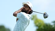 Akshay Bhatia plays his shot from the first tee during the third round of the 3M Open golf tournament. 