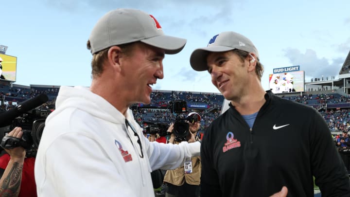 Feb 4, 2024; Orlando, FL, USA; NFC coach Eli Manning and AFC coach Peyton Manning react after the 2024 Pro Bowl at Camping World Stadium. 