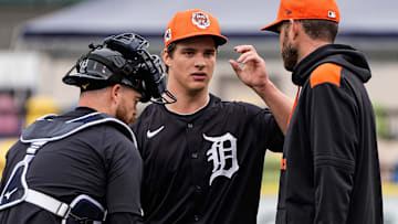 Detroit Tigers pitcher Jackson Jobe, center, talks to j, left, and pitching coach Chris Fetter during spring training at Joker Marchant Stadium in Lakeland, Fla. on Thursday, Feb. 20, 2025.
