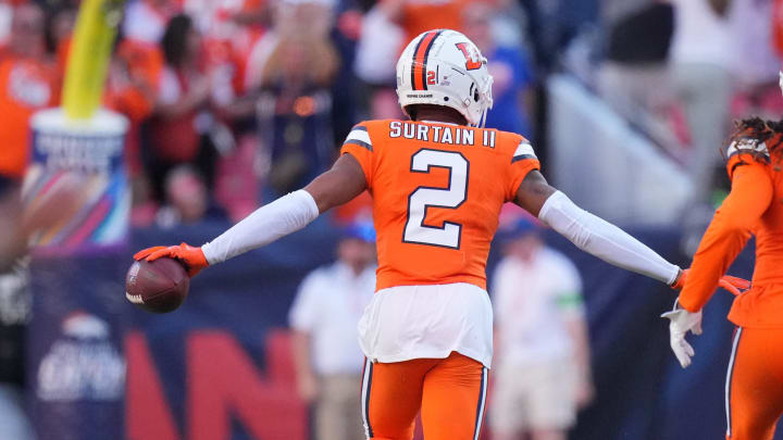 Oct 8, 2023; Denver, Colorado, USA; Denver Broncos cornerback Pat Surtain II (2) celebrates his interception with cornerback Tremon Smith (1) in the second half against the New York Jets at Empower Field at Mile High.  