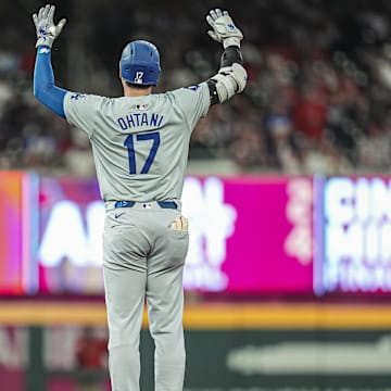 Sep 15, 2024; Cumberland, Georgia, USA; Los Angeles Dodgers designated hitter Shohei Ohtani (17) reacts after hitting a double to drive in a run against the Atlanta Braves during the seventh inning at Truist Park.