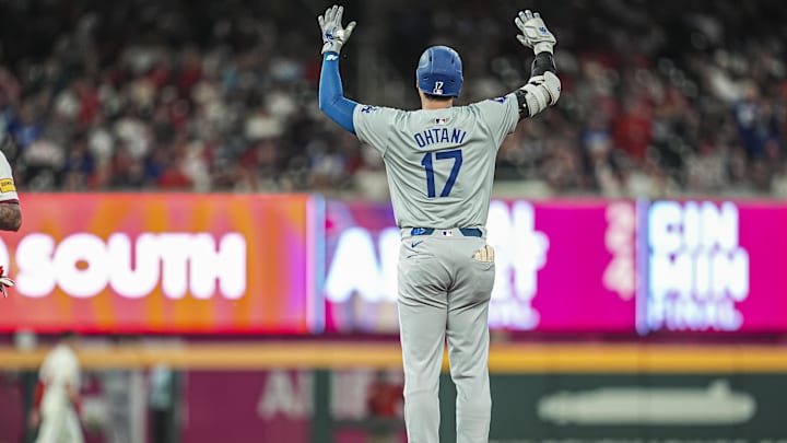 Sep 15, 2024; Cumberland, Georgia, USA; Los Angeles Dodgers designated hitter Shohei Ohtani (17) reacts after hitting a double to drive in a run against the Atlanta Braves during the seventh inning at Truist Park.