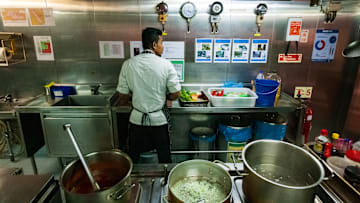 A chef cooks in the galley of a ship, Oman sea, Indian Ocean British Territorry