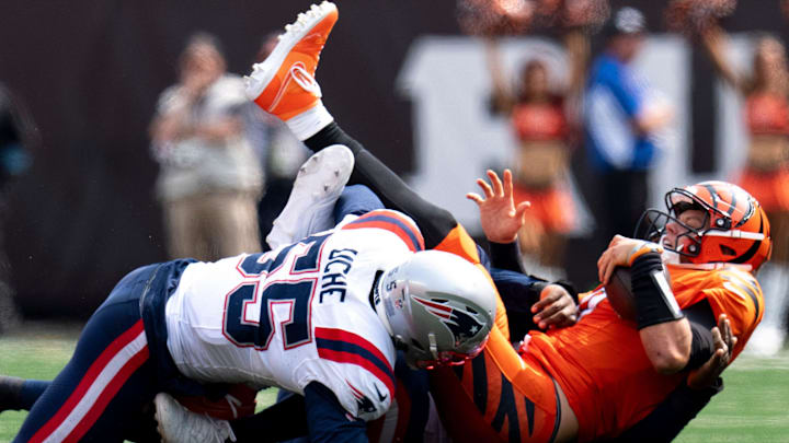 New England Patriots defensive end Keion White (99) and New England Patriots linebacker Joshua Uche (55) tackles Cincinnati Bengals quarterback Joe Burrow (9) in the fourth quarter of the NFL game at Paycor Stadium in Cincinnati on Sunday, Sept. 8, 2024.