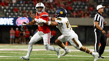 Sep 7, 2024; Tucson, Arizona, USA; Arizona Wildcats quarterback Noah Fifita (11) rolls out to pass against Northern Arizona Lumberjacks linebacker Tommy Ellis (46) during first quarter at Arizona Stadium. 