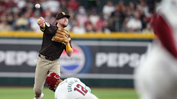 San Diego Padres infielder Jake Cronenworth (9) throws over Arizona Diamondbacks base runner Lourdes Gurriel Jr. (12) for the double play at Chase Field on Sept. 29, 2024.