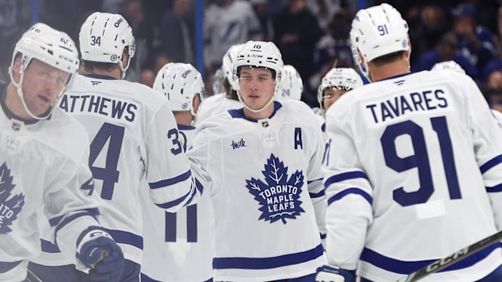 Apr 9, 2025; Tampa, Florida, USA;Toronto Maple Leafs right wing Mitch Marner (16), center Auston Matthews (34) and teammates celebrate after they defeated the Tampa Bay Lightning at Amalie Arena. Mandatory Credit: Kim Klement Neitzel-Imagn Images