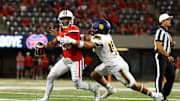 Sep 7, 2024; Tucson, Arizona, USA; Arizona Wildcats quarterback Noah Fifita (11) rolls out to pass against Northern Arizona Lumberjacks linebacker Tommy Ellis (46) during first quarter at Arizona Stadium.