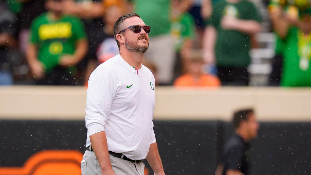 Oregon head coach Dan Lanning takes in the rain as the Oregon Ducks face the Oklahoma State Cowboys. Oregon head coach Dan Lanning takes in the rain as the Oregon Ducks face the Oklahoma State Cowboys.