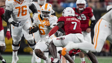 Sep 7, 2024; Charlotte, North Carolina, USA; Tennessee Volunteers running back Dylan Sampson (6) runs as North Carolina State Wolfpack safety Bishop Fitzgerald (7) defends during the second half at the Dukes Mayo Classic at Bank of America Stadium. Mandatory Credit: Jim Dedmon-Imagn Images