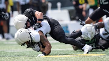 Combat Ducks inside linebacker Brayden Platt brings down Fighting Ducks running back Makhi Hughes as the Fighting Ducks face off against Mighty Oregon in the Oregon Ducks spring game on April 26, 2025, at Autzen Stadium in Eugene.
