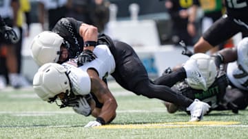 Combat Ducks inside linebacker Brayden Platt brings down Fighting Ducks running back Makhi Hughes as the Fighting Ducks face off against Mighty Oregon in the Oregon Ducks spring game on April 26, 2025, at Autzen Stadium in Eugene.