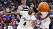 Mar 22, 2025; Denver, CO, USA; Texas A&M Aggies guard Wade Taylor IV (4) attempts to get the ball against the Michigan Wolverines during the second half in the second round of the NCAA Tournament  at Ball Arena. Mandatory Credit: Ron Chenoy-Imagn Images