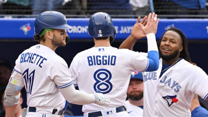 Sep 16, 2023; Toronto, Ontario, CAN; Toronto Blue Jays pinch runner Cavan Biggio (8) celebrates with shortstop Bo Bichette (11) and first baseman Vladimir Guerrero Jr. (27) after scoring against the Boston Red Sox in the ninth inning at Rogers Centre. Mandatory Credit: Dan Hamilton-USA TODAY Sports