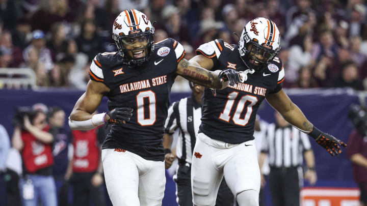 Dec 27, 2023; Houston, TX, USA; Oklahoma State Cowboys wide receiver Rashod Owens (10) celebrates with running back Ollie Gordon II (0) after scoring a touchdown during the first quarter against the Texas A&M Aggies at NRG Stadium. Mandatory Credit: Troy Taormina-USA TODAY Sports