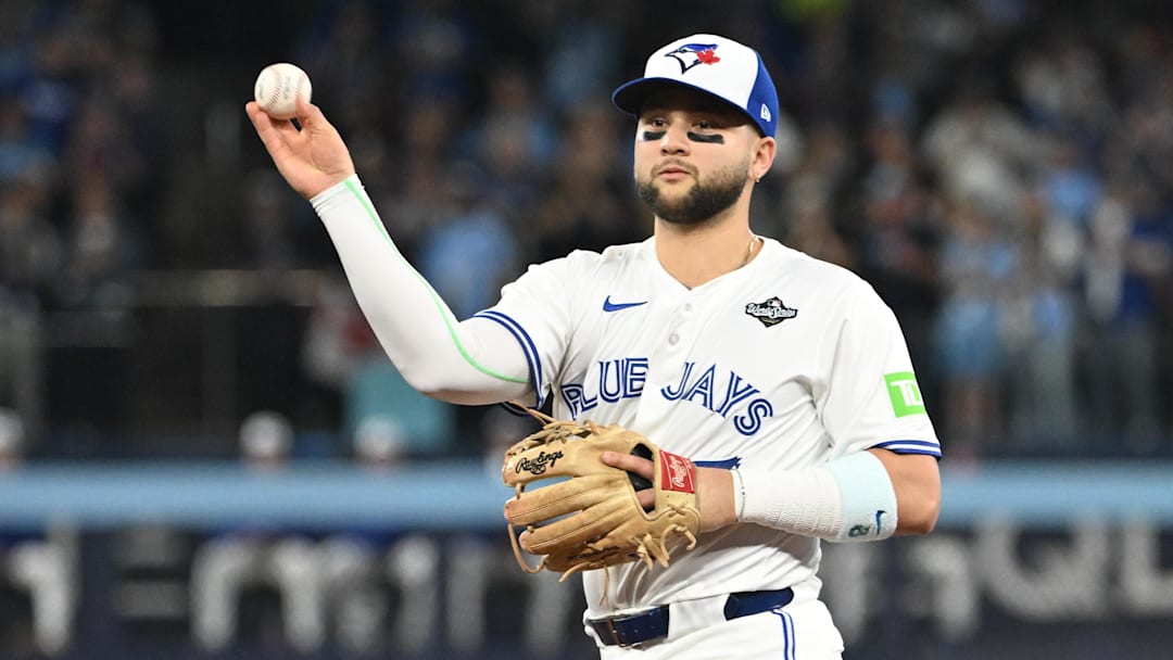 Toronto Blue Jays second baseman Bo Bichette (11) makes a play to get out Los Angeles Dodgers first baseman Freddie Freeman (not pictured) in the first inning during game one of the 2025 MLB World Series at Rogers Centre.