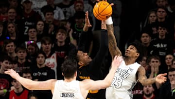 Cincinnati Bearcats forward Dillon Mitchell (23) blocks Arizona State Sun Devils guard/forward BJ Freeman (10) in the first half of the NCAA basketball game at Fifth Third Arena in Cincinnati on Saturday, January 18, 2025.