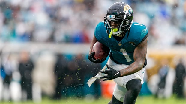 Jacksonville Jaguars running back Travis Etienne Jr. (1) runs the ball against the Tennessee Titans.